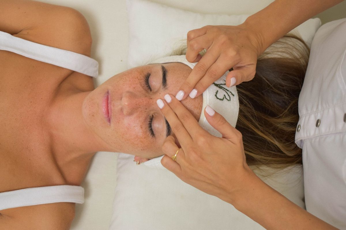 Skincare professional providing a calming facial treatment at Serenity Aesthetics & Spa in Charlotte, NC